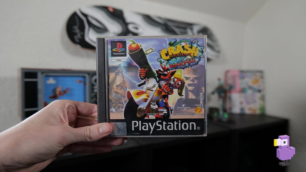 Crash Bandicoot Warped PS1 case held by Rob in his studio